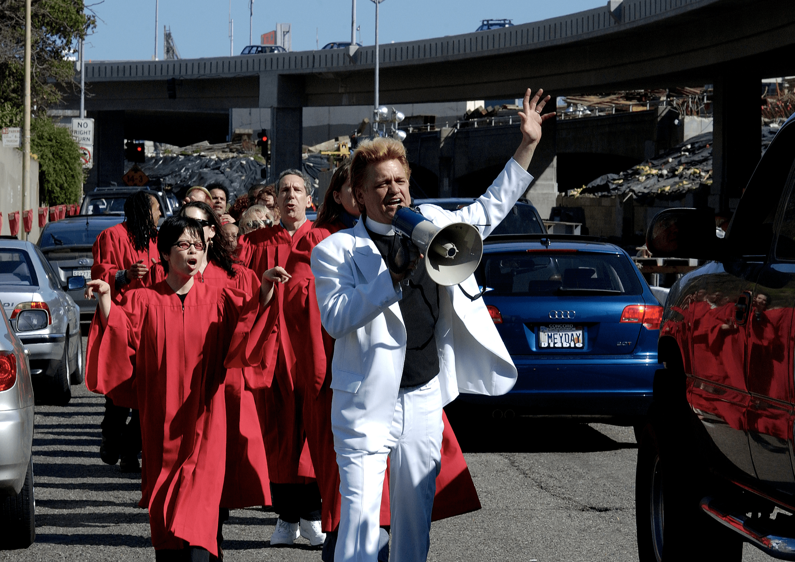 RevBilly leading The Stop Shopping Choir in red robes